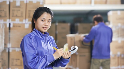 two chinese workers in warehouse