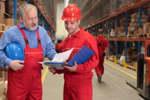 two workers in uniforms in warehouse